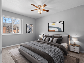 Cedar Rapids apartment for rent - a bedroom with a large bed and a ceiling fan