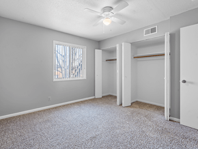 Cedar Rapids apartment for rent - a bedroom with a ceiling fan and a window