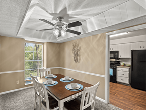Kansas City apartment for rent - a dining room with a table and chairs and a ceiling fan