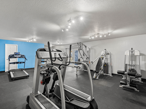 Kansas City apartment for rent - a gym with weights and cardio equipment at the enclave at woodbury