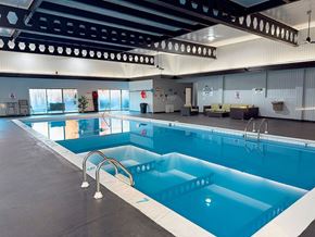 Muskegon apartment for rent - A large indoor swimming pool with a diving board.
