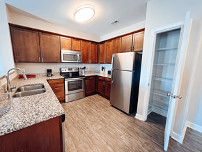 Scott Depot apartment for rent - A kitchen with wooden cabinets and a refrigerator.