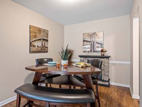 Muskegon apartment for rent - a dining room with a table and chairs in front of a fireplace