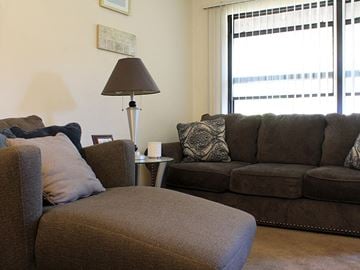 Hazelwood apartment for rent - a living room with couches and a lamp and a window