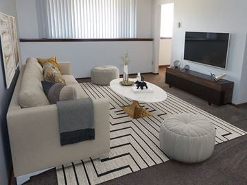 Rochester townhouse for rent - a living room with a couch and a television