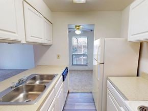 Maryland Heights apartment for rent - A kitchen with white cabinets and a stainless steel sink.