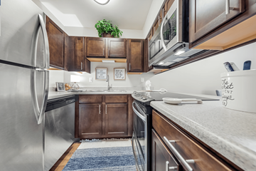 Maryland Heights apartment for rent - A kitchen with a refrigerator, sink, and stove.