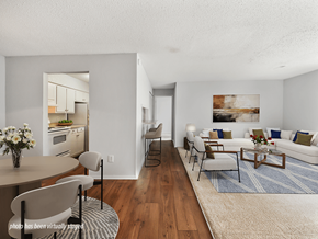 Fayetteville apartment for rent - A living room with a couch, chairs, and a coffee table.