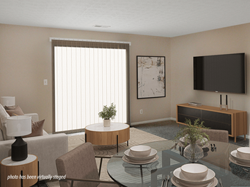 Columbus apartment for rent - A living room with a glass table and a television on the wall.