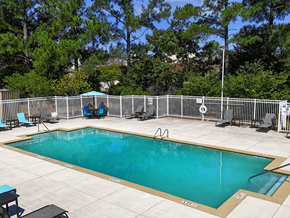 Columbia apartment for rent - A small pool surrounded by a fence and trees.