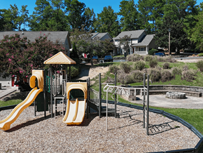 Columbia townhouse for rent - A playground with a yellow slide and a green and yellow playhouse.