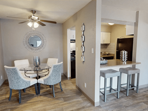 Albuquerque apartment for rent - A modern dining room with a glass table and chairs.
