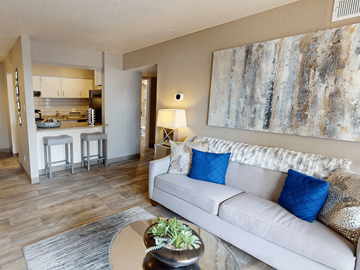Albuquerque apartment for rent - A living room with a couch, a table, and a painting on the wall.