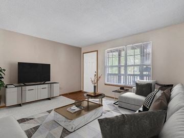 Cedar Rapids apartment for rent - a living room with a couch and a tv