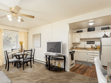 Fairborn townhouse for rent - a living room and kitchen with a tv and a table
