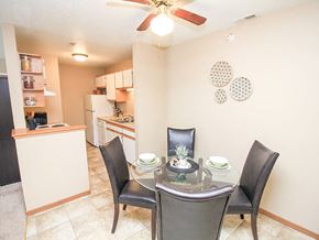 South Sioux City apartment for rent - a dining room with a table and chairs and a kitchen in the background