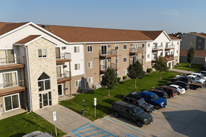 Williston apartment for rent - A parking lot in front of apartment buildings.