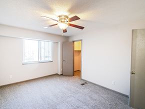 Wichita townhouse for rent - A room with a ceiling fan and a door.