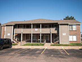 Wichita townhouse for rent - A building with a parking lot in front of it.