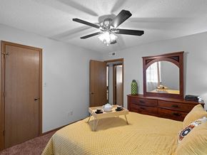 Topeka apartment for rent - a bedroom with a bed and a ceiling fan