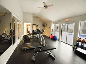 Wichita apartment for rent - apartment gym with a ceiling fan and exercise equipment