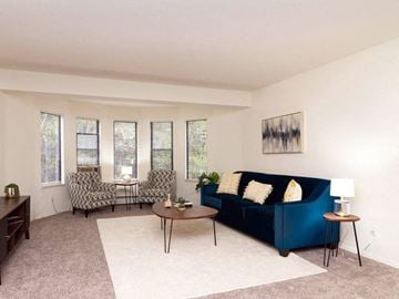 Grand Rapids apartment for rent - a living room with a blue couch and chairs