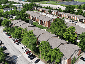 Mehlville townhouse for rent - Apartment complex with a parking lot in front.