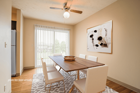 Omaha triplex for rent - A dining room with a wooden table and chairs.