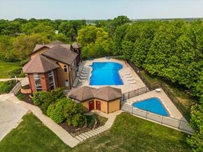 Omaha triplex for rent - arial view of a house with a large pool in the backyard