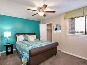 Wichita apartment for rent - a bedroom with a bed and a ceiling fan