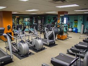 Minot apartment for rent - a room filled with cardio equipment and weights