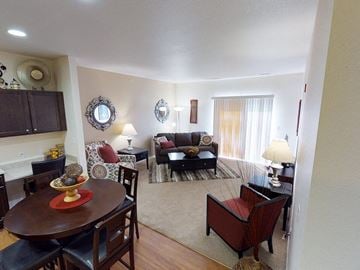 Minot apartment for rent - a living room and dining room with a couch and a table
