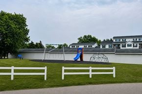 Holland apartment for rent - A playground with a slide and a swing set.