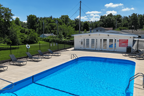 Omaha apartment for rent - A pool with a blue tiled edge and a white building in the background.