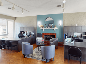 Maryland Heights townhouse for rent - A living room with a grey couch and a fireplace.