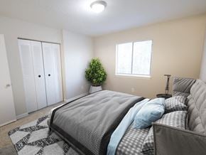 New Bern apartment for rent - A bedroom with a large bed and a potted plant.