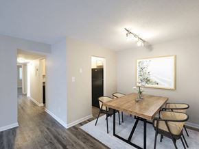 New Bern apartment for rent - A dining room with a wooden table and chairs.