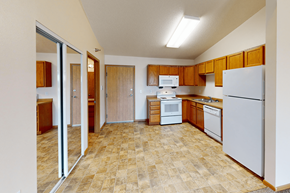 Williston apartment for rent - A kitchen with a white refrigerator, white microwave, and white oven.