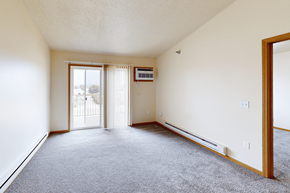 Williston apartment for rent - A sparsely furnished room with a sliding glass door.