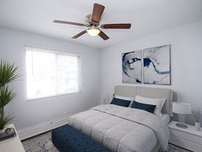 Sioux City apartment for rent - a bedroom with a bed and a ceiling fan