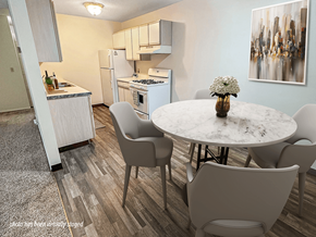 Brooklyn Park apartment for rent - A kitchen with a table and chairs in the foreground and a refrigerator and cabinets in the background.