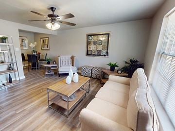Little Rock apartment for rent - A living room with a white couch and a wooden coffee table.