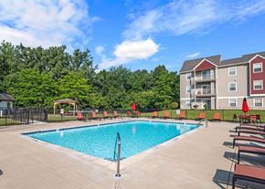 Fenton apartment for rent - a swimming pool in front of an apartment building