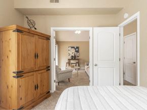 Topeka apartment for rent - a bedroom with a bed and a dresser and a living room