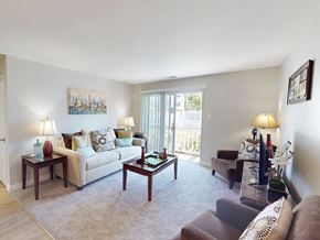 Florissant apartment for rent - A living room with a couch, chairs, and a coffee table.