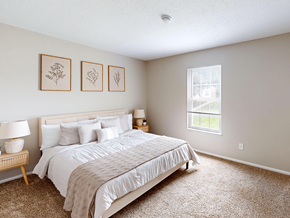 Fenton apartment for rent - A bedroom with a large bed and a window.