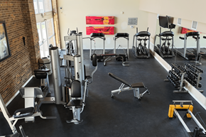 Omaha townhouse for rent - A gym with a variety of equipment including weights and weight machines.
