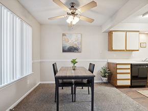 Cedar Rapids townhouse for rent - dining room with a table and a ceiling fan