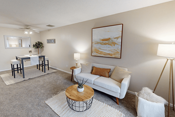 Cedar Rapids townhouse for rent - A living room with a white couch, a coffee table, and a painting on the wall.
