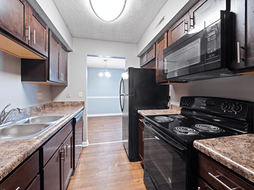 Clarksville apartment for rent - a kitchen with black appliances and granite counter tops